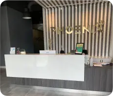 Phoenix Physio reception desk with the gold Phoenix sign