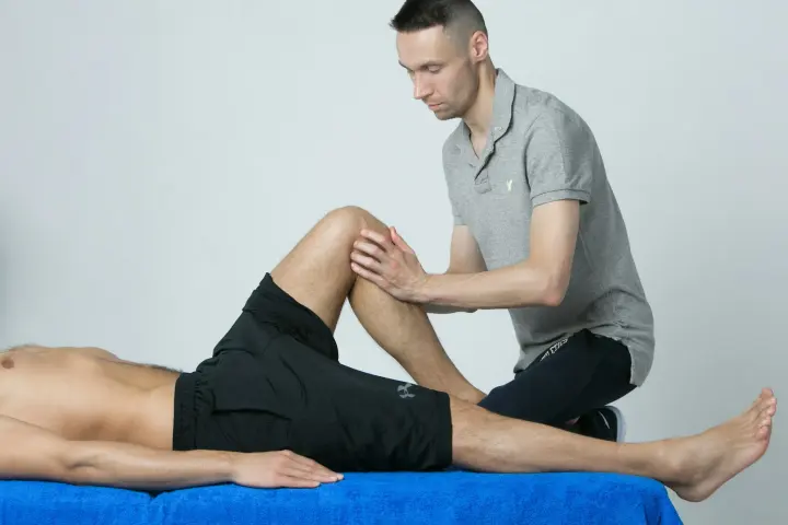Physiotherapist assessing a patient's knee at Phoenix Physio in Concord